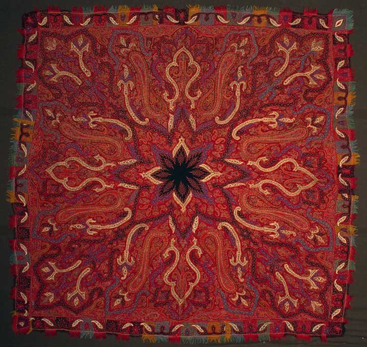 AMLI SHAWL, KASHMIR, 19TH C: Red ground w/ black center embroidered predominantly in red, blue, black, yellow & white, multicolored fringed gates, 67" x 67", (few small holes) excellent.