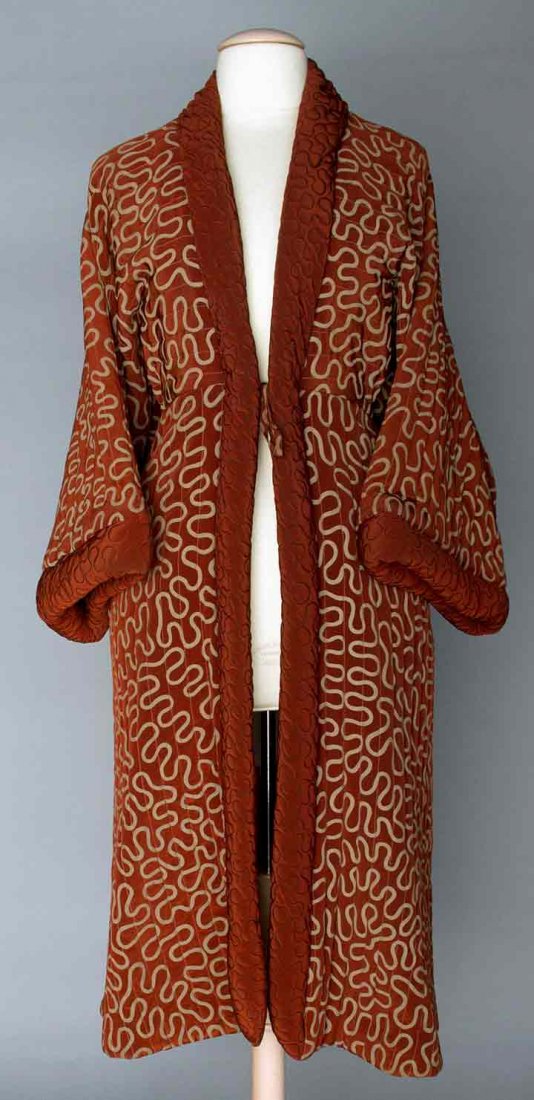 ZANDRA RHODES QUILTED COAT, LONDON, 1980-1990: Cinnamon w/ gray vermicelli pattern, empire w/ cased elastic back, kimono sleeves, inside front tie, slash side pockets, satin lining, labeled "Zandra Rhodes London", L 47", size small, excellent.