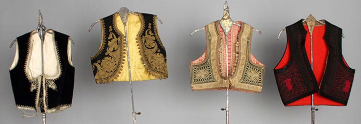 FOUR REGIONAL VESTS, 1875-1920: 1 Serbian woman's black velvet w/ silver metallic soutache & braid; 3 Albanian: 1 forest green velvet w/ metallic gold soutache; 1 man's burgundy wool w/ black soutache; 1 black wool w/ gold soutache;