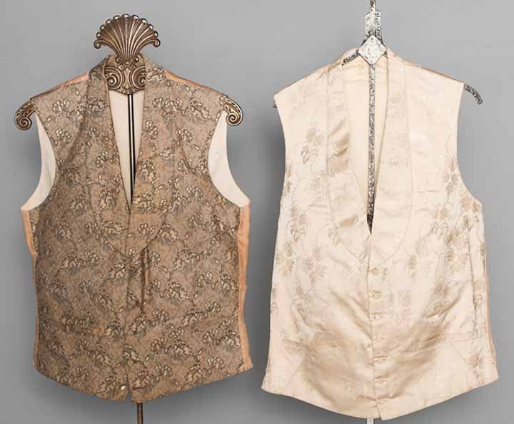 TWO GENTS BROCADE WAISTCOATS, 1840-1850s: Both silk w/ padded chests, narrow shawl collars, 3 F pockets & buckle backs: 1 ivory satin w/ delicate floral pattern, CH 38", L 23", (rip on B, 2 tiny pen marks on F); 1 stylized landscape pattern w