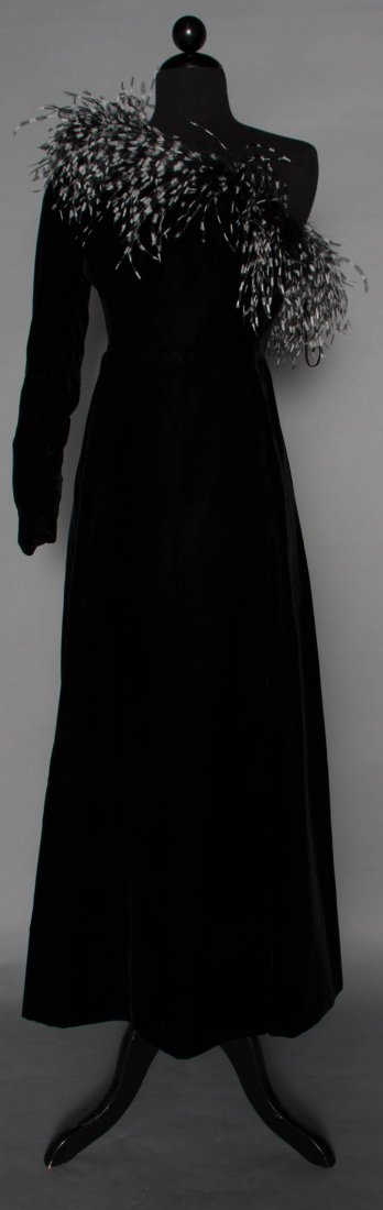 GIVENCHY COUTURE FEATHERED GOWN, 20TH C: Black velvet, single long sleeve w/ neckline cutting diagonally across chest & trimmed in black & white ostrich feathers, B 34", W 28", L 51", labeled & with stamped tape "44323", (gown originally had