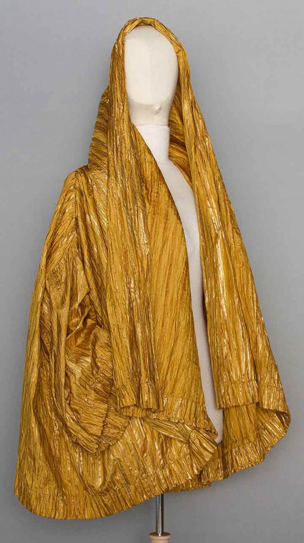 ROMEO GIGLI GOLD EVENING JACKET, 1980s: Voluminous jacket, crinkle pleated synthetic blend w/ metallic rose gold vertical stripes, deep shawl collar, tubular 3/4 sleeves, 2 F patch pockets, labeled & marked IT size 44, excellent.