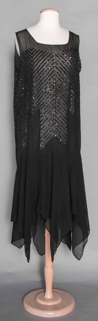 BEADED DANCE DRESS, LATE 1920s: Black silk chiffon, handkerchief hem, rows of black beads & sequins in chevron patterns, sleeveless, B 40", H 40", L 50", (minor sequin & bead losses) excellent. Suddon-Cleaver Costume Collection