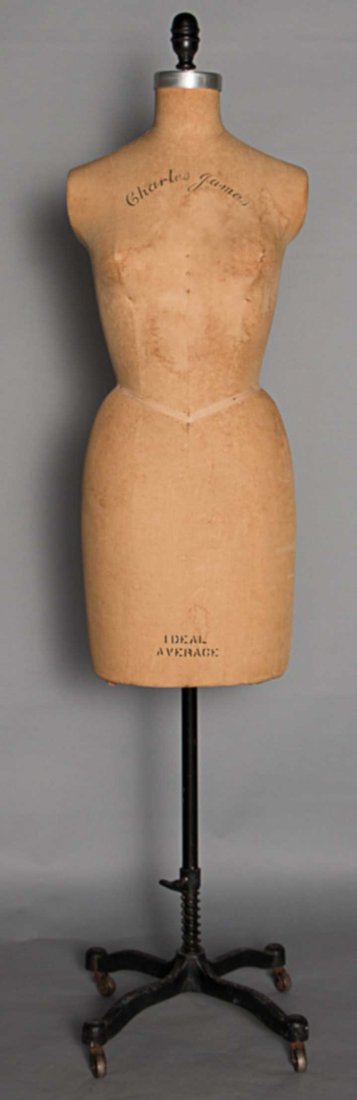 CHARLES JAMES DRESS FORM, 1950s: Ecru linen cloth covered torso, "Charles James" stamped in script above breasts & "Ideal Average" stamped at bottom of form, Sh-Sh 14", B 36", W 24.5", H 36", adjustable cast iron 4 claw & wheel stand