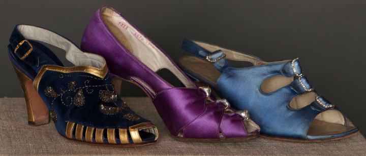 THREE PAIR EVENING SANDALS, 1930s: 2 pair silk satin: 1 purple w/ silver leather, size 7AA, Heel 3.25", excellent; 1 Delman pair sky blue w/ 3 silver buckles, Size 8M, Heel 2.25", (light stains) very good; 1 pair cobalt blue velvet w/ 