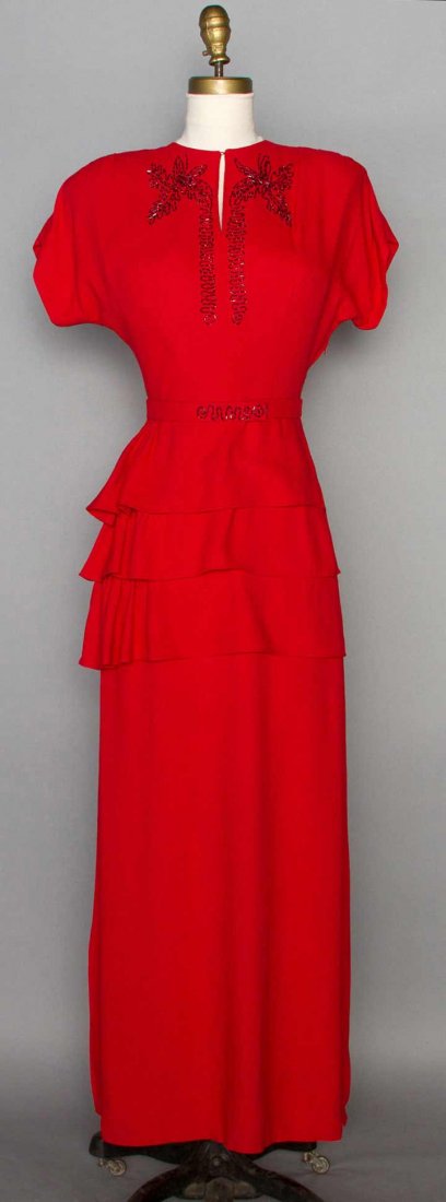 BEADED RED EVENING DRESS, 1940s: Lightweight wool crepe, cap sleeves, red bugle beaded trim on top & belt, long straight skirt w/ 3 flounced tiers, B 32", W 25.5", L 56", excellent.