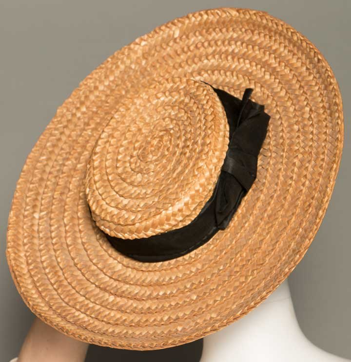 LADY'S STRAW SUMMER HAT, c. 1902: Exaggerated wide brim boater of natural straw braid, shallow crown, black silk ribbon band & bow, Wd ", excellent.