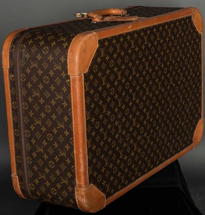 LOUIS VUITTON HARD SUITCASE, c. 1980: Exterior brown cloth w/ gold logo stamping, leather calfskin edging, handle & luggage tag, brass hardware, double zipper - all metal logo stamped, beige leather interior w/ 2 side pockets & logo woven