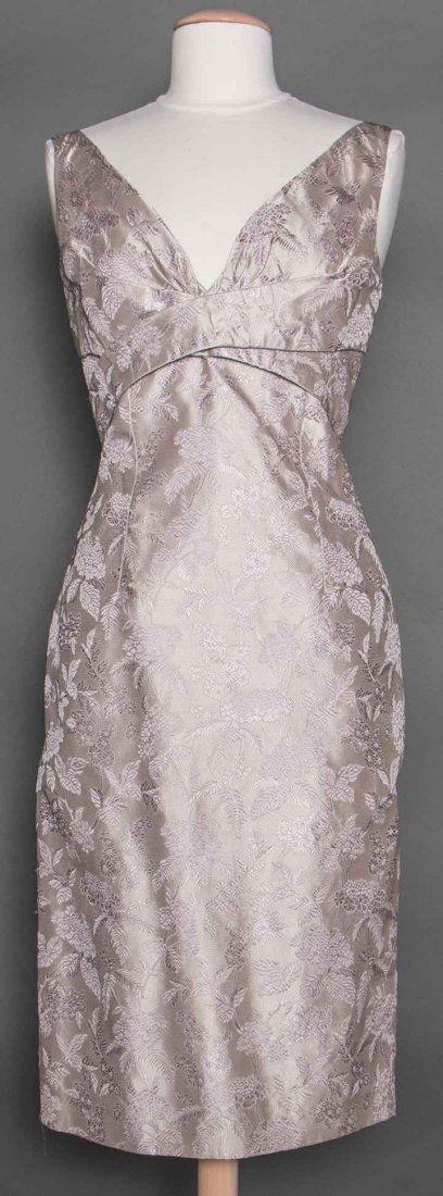ALEXANDER McQUEEN LILAC SILK DRESS, S-S 2005: Pale lilac figured silk w/ hydrangea woven pattern, below knee sleeveless sheath, empire waist w/ criss-cross bands, deep V neck, label "Alexander McQueen Made in Italy", French size 42, B 36", W 29",