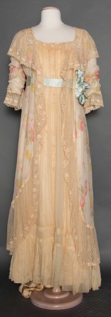 PRINTED SILK BELLE EPOQUE NEGLIGEE: Ivory chiffon printed w/ pink & yellow roses, CF of ivory chiffon, blue silk ribbon at empire bodice & cuffs, embroidered floral baskets on wide net lace trims, B 36", W 30", L 55", (CF ivory panel st