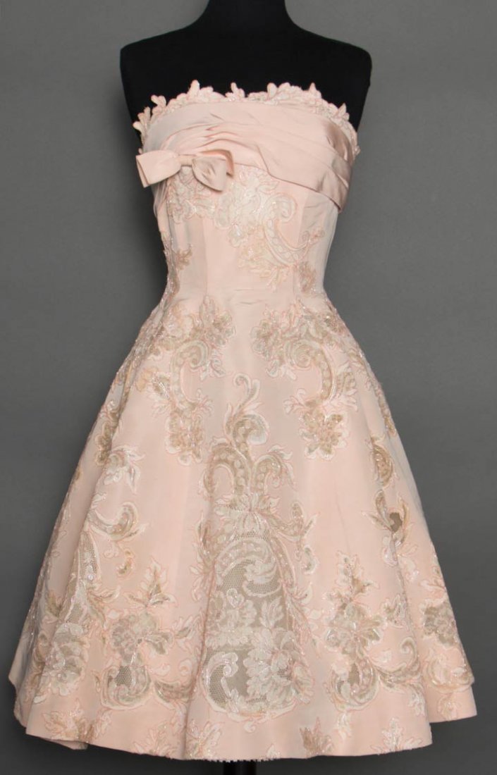 PIERRE BALMAIN PARTY DRESS, 1950s: Unlabeled, museum attribution, pale pink silk faille w/ Alencon lace inserts outlined in irridescent pink cord, backed w/ cotton net, strapless, built-in bodice foundation, B 34", W 23", CFL 34", (min