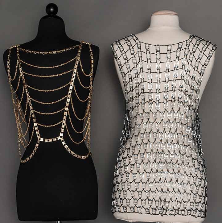 TWO LADIES' METAL VESTS, LATE 20TH C: 1 gold metal constructed in rows of swags, L 18"; 1 tank top worked in silver pop tabs joined together w/ black crochet stitching, L 28", both excellent.