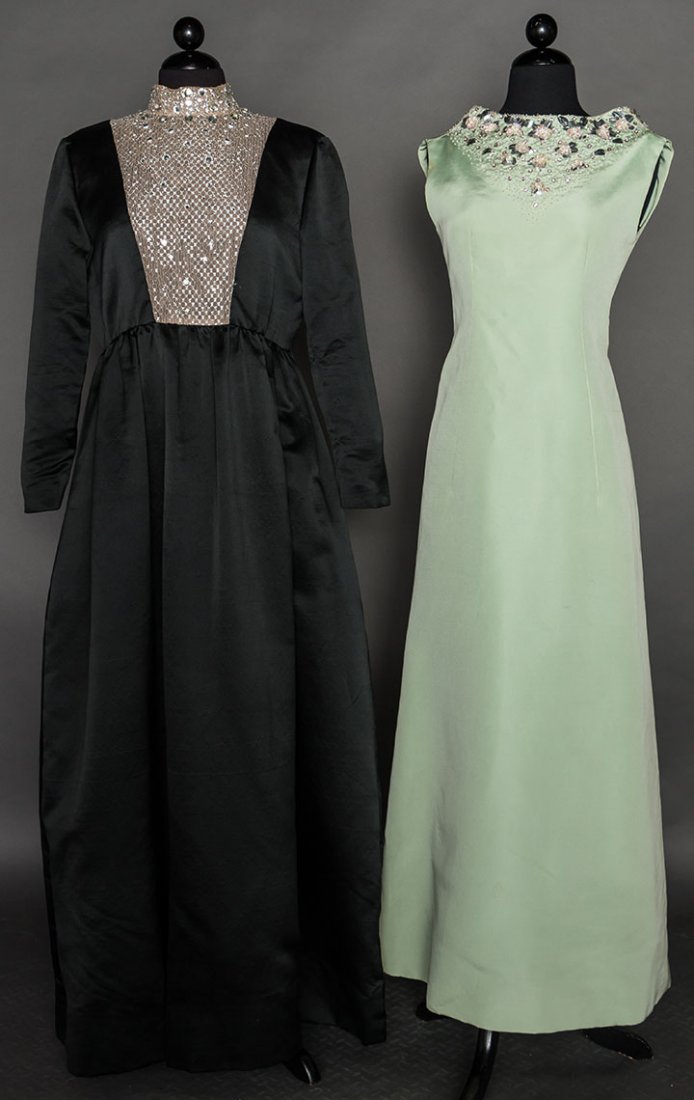 TWO EVENING GOWNS, 1960-1970s: 1 "Teal-Traina" black silk satin, high W, CF mesh & jeweled plastron, side pockets, B 38"-40", Hi W 32" L 59", excellent; 1 "Oscar de La Renta" mint green faille, sleeveless, neckline w/ pink, white &