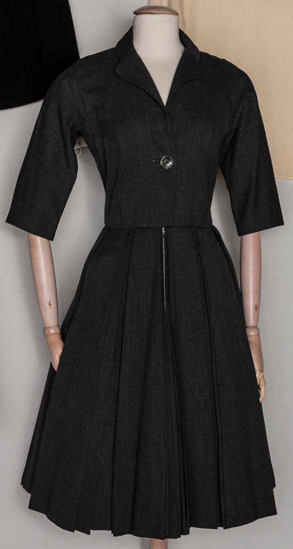 SEVEN LADIES' GARMENTS, LATE 1950s-1965: 1 "Galanos" grey spring wool day dress; 1 "Adolfo" black wool circle skirt; 1 unlabeled Renato Belastra heavy white silk dress; 2 "Mainbocher" sweaters, 1 black cashmere cardigan & 1 unlabeled red woo