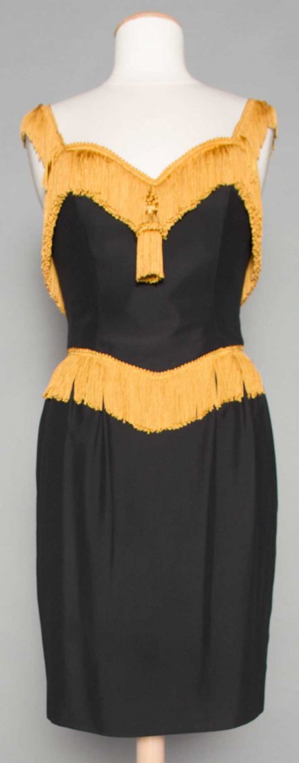 MOSCHINO FRINGED MINI DRESS, 1990s: Black sheath trimmed w/ gold fringe & tassel, labeled, B 36", W 27", H 42", L 40", FR size 40, excellent.