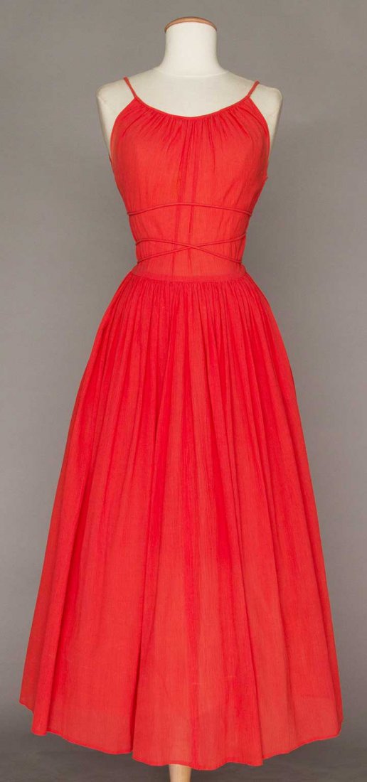 CLAIRE McCARDELL CORAL SUMMER DRESS, 1949: Cotton crepe w/ scoop neckline & spaghetti straps, long gathered skirt, self fabric cord waist tie, labeled, B 34"-36", W 26.5", L 52", (small back skirt stain) fair.