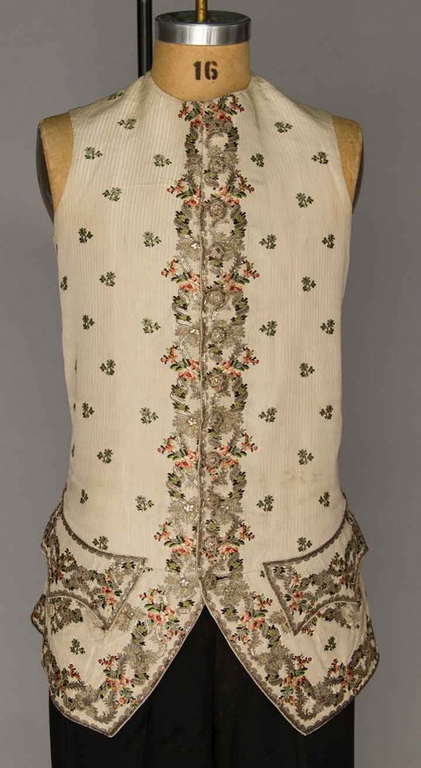 EMBROIDERED SILK WAISTCOAT, ENGLAND, 1770s: Cream silk woven w/ green & rose flowers & metallic silver ribbon, silver sequin embroidery, 2 flap pockets w/ 3 buttons beneath, 12 CF gilt buttons, coarse cotton backing, cotton & silk linings, CH 3