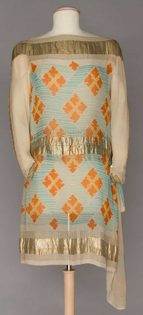 PRINTED SILK & LAME DINNER DRESS, c. 1928: Cream silk chiffon printed w/ orange diamonds on blue stripes, woven gold lame bands, hip scarf & cloth flower, B 32"-34", H to 38", L 35", (seam separation under right arm, 1 shoulder stain) very goo
