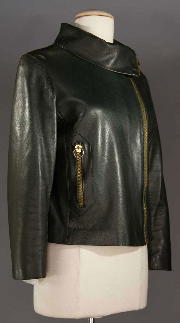 PIERRE CARDIN GREEN LEATHER JACKET, 1970s: Dark bottle green, fold-over mock turtle neck, gold off-center zipper from collar edge to hem, vertical zipper to side pocket, label "Le Vetements de Peau de Pierre Cardin Paris", B to 36", excellent.