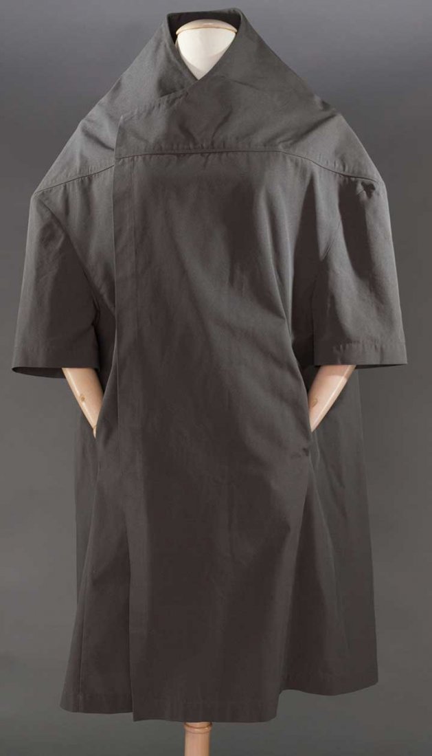 RICK OWENS DEADSTOCK COAT, ISLAND COLLECTION, S-S 2003: Tight honeycomb woven silk in gun metal grey, short sleeves, collarless & barrel shaped, labeled & w/ original hang tags, US size 6, same coat shown on runway, excellent.