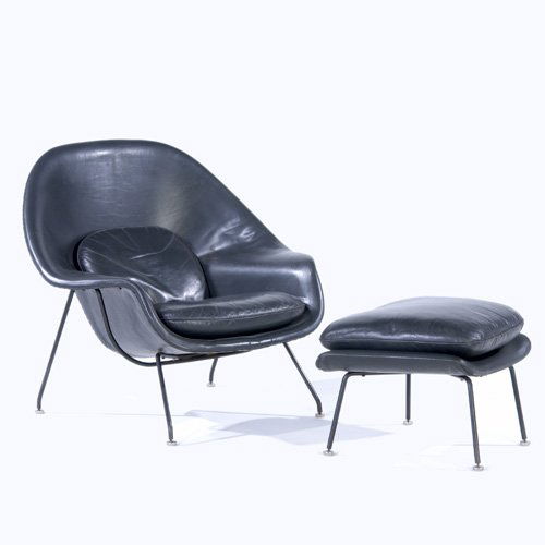 EERO SAARINEN / KNOLL Womb chair and ottoman upho: EERO SAARINEN / KNOLL Womb chair and ottoman upholstered in dark grey leather. Chair with Knoll label. 36" x 38 1/2" x 29"