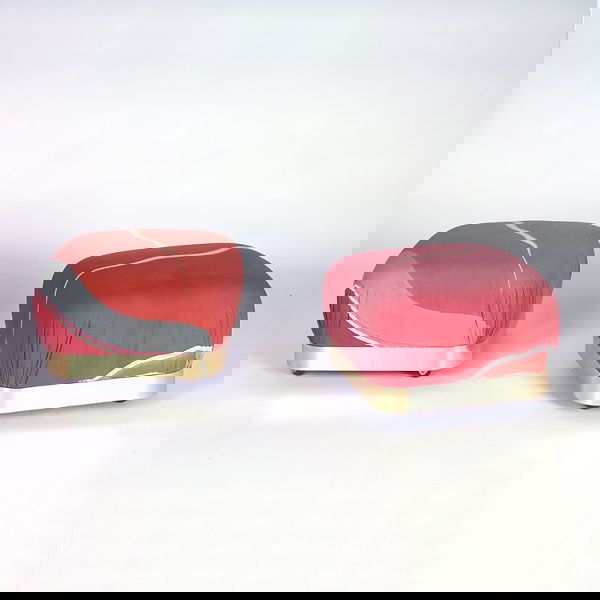 KARL SPRINGER Two ottomans, each with printed fabr: KARL SPRINGER Two ottomans, each with printed fabric upholstery on brass base with casters. Unmarked. 16" x 23" sq.