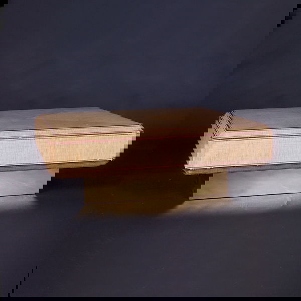 KARL SPRINGER Coffee table with square beveled top: KARL SPRINGER Coffee table with square beveled top, lacquered grasscloth finish with burgundy trim, and brass-clad wood base. Some minor losses, mostly to trim. Unmarked. 16 1/2" x 48" sq.