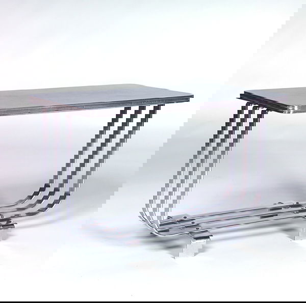 WOLFGANG HOFFMANN/HOWELL Side table with rectangu: WOLFGANG HOFFMANN/HOWELL Side table with rectangular black laminate top and chrome trim, on triple-banded polished chrome base. Unmarked. 18" x 27" x 16"