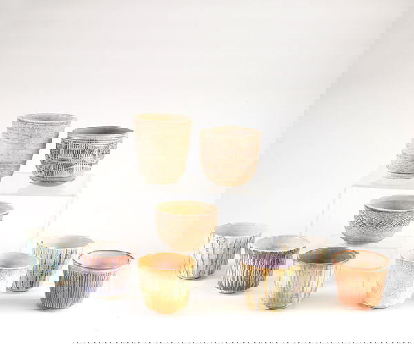 LEE ROSEN Nine earthenware planters in assorted s: LEE ROSEN Nine earthenware planters in assorted sizes with either painted or incised decoration. (Acquired from the artist's estate). A couple of small chips. Two marked with Design Technics cipher. L