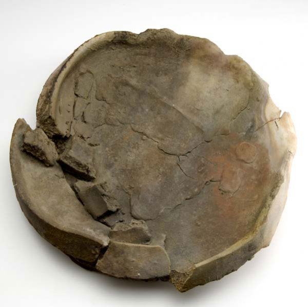 PETER VOULKOS Large raku-fired plate with torn chu: PETER VOULKOS Large Anagama-fired plate with torn chunks, 1995. Signed and dated. (Provenance: Carl M. Allen; Charles Cowles Gallery.) 5" x 21"