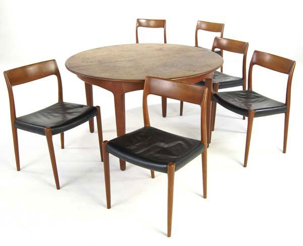 SCANDINAVIAN Teak extension dining table with four: SCANDINAVIAN Teak extension dining table with four 20" leaves, and six matching side chairs upholstered in black leather. Chairs marked with J.L. Moller Models tag. Table (closed): 29" x 49" dia., cha
