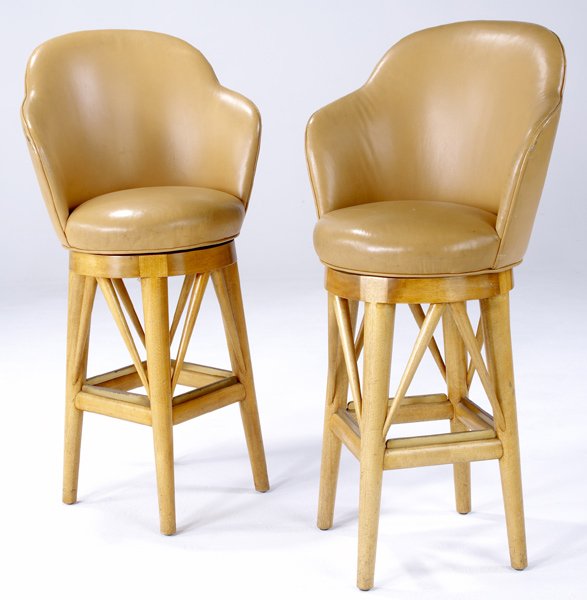 PAUL LASZLO Pair of custom barstools with tan leat: PAUL LASZLO Pair of custom barstools with tan leather-covered seats on sycamore and brass frames. 43" x 22" x 22"