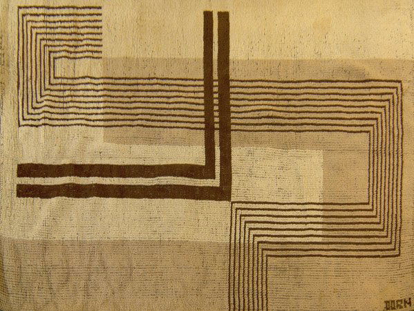 MARION DORN Woven wool rug with abstract design in: MARION DORN Woven wool rug with abstract design in cream and brown. Woven signature. 80" x 60"