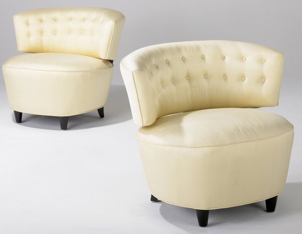 GILBERT ROHDE Pair of barrel chairs: GILBERT ROHDE Pair of barrel chairs upholstered in cream silk on ebonized wood feet. 29" x 34" x 30"