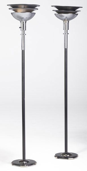 GILBERT ROHDE Pair of torcheres in chromed steel: GILBERT ROHDE Pair of torcheres in chromed steel and black painted metal. Each: 68" x 14"