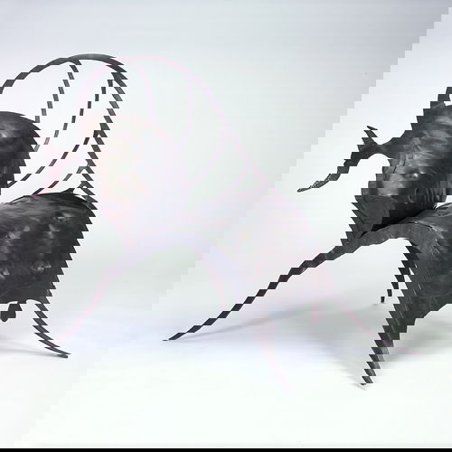 Jon Mills "Bull" lounge chair, 1980s, welded steel: Jon Mills "Bull" lounge chair, 1980s, welded steel with undulating rectangular seat, raised spine and outswept legs charcoal patina and applied details. Unmarked. 42" x 43" x 57"