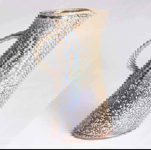 DON REITZ Stoneware pitcher with ribbon handle, co: DON REITZ Stoneware pitcher with ribbon handle, covered in a blue and green vained glossy glaze. Signed "Reitz". 10 3/4" x 6 3/4".