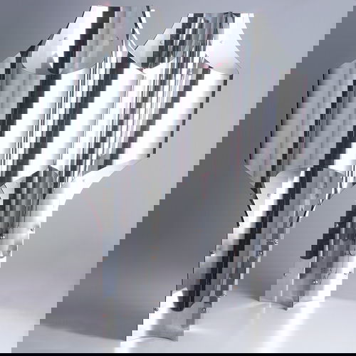 ROBERT SONNEMAN Pair of tall table lamps, 1970s, o: ROBERT SONNEMAN Pair of tall table lamps, 1970s, of bent and riveted metal with polished chrome exterior, and four sockets. Unmarked. 32" x 16 1/4".