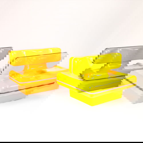 LA DEFENSE Pair of French cast fiberglass settees: LA DEFENSE Pair of French cast fiberglass settees, c. 1983, one double-sided in bright yellow (commissioned for the Neptune Towers in Paris). 33" x 45" x 41"