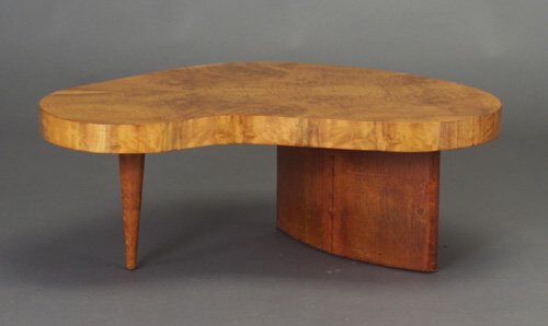 Fine GILBERT ROHDE for HERMAN MILLER Pal: Fine GILBERT ROHDE for HERMAN MILLER Paldao coffee table with kidney-shaped Acacia burl top on leatherette-wrapped curved plank support and tapering front leg. Stenciled 4189. 15 1/4" x 41" x 26"