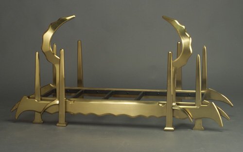 ALBERT PALEY logholder of forged and fab: ALBERT PALEY logholder of forged and fabricated bronze with scalloped apron and eight faceted spire uprights, two with crescent-shaped buttresses, covered in a polished brass finish. Unmarked. 36 1/2"