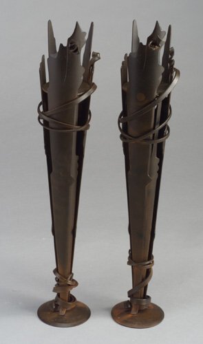 Pair of ALBERT PALEY forged and fabricat: Pair of ALBERT PALEY forged and fabricated steel "Vulcan" tall candlesticks, 1994, with dark brown patina and rust-colored flashes. Stamped Albert Paley/1994. 20 1/2" h