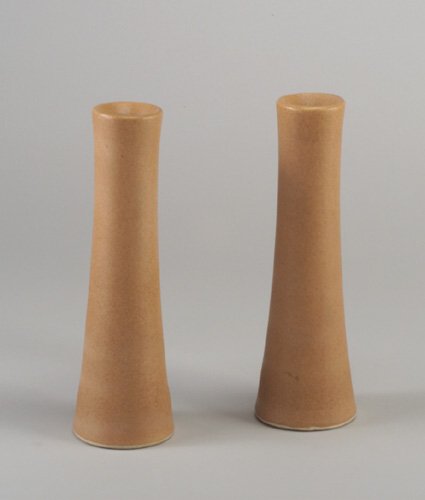 Pair of RUSSEL WRIGHT for BAUER tapering: Pair of RUSSEL WRIGHT for BAUER tapering candlesticks covered in speckled apricot matte glaze. Unmarked. 11"