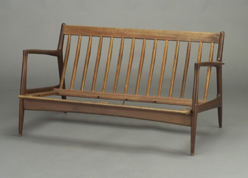 Danish settee with open arms and slatted: Danish settee with open arms and slatted back on tapering dowel leg frame. Red & white metal import tag (Selig). 27" x 52 1/4" x 32"