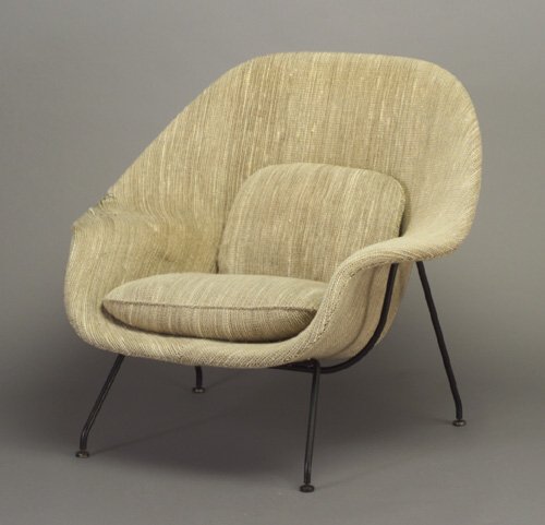 EERO SAARINEN for KNOLL "Womb" chair, it: EERO SAARINEN for KNOLL "Womb" chair, its frame and two loose cushions upholstered in beige and black tween fabric, on tubular black metal base. Some tears/fraying to upholstery. Marked with upholster