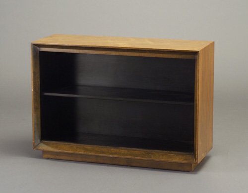 GILBERT ROHDE for HERMAN MILLER cabinet: GILBERT ROHDE for HERMAN MILLER cabinet with two sliding glass doors, and ebonized interior with single shelf. Herman Miller factory tag, and stenciled number. 25" x 36" x 13"