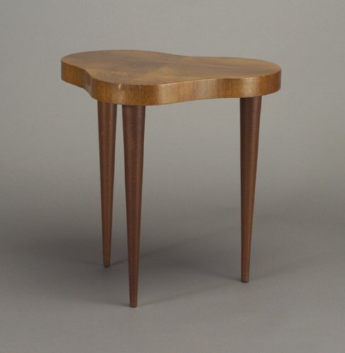 Fine GILBERT ROHDE for HERMAN MILLER Pal: Fine GILBERT ROHDE for HERMAN MILLER Paldao lamp table with biomorphic top on three tapering leatherette-wrapped legs. Some minor veneer chips and nicks along edges. Foil label and factory tag. 27" x