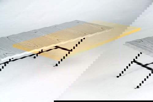 TAPIO WIRKKALA/ASKO Coffee table with rectangular: TAPIO WIRKKALA/ASKO Coffee table with rectangular laminated plywood top in "Whirlwind" pattern, on black iron base, 1996. Metal tag. 16" x 49" x 24 1/4"