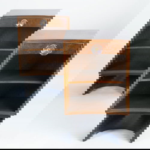 GILBERT ROHDE/HERMAN MILLER Pair of curved nights: GILBERT ROHDE/HERMAN MILLER Pair of curved nightstands, each with single drawer and circular lucite pull over two cubicles, on ebonized U-shaped base. Stenciled number to back of one. 26" x 15 1/4" x