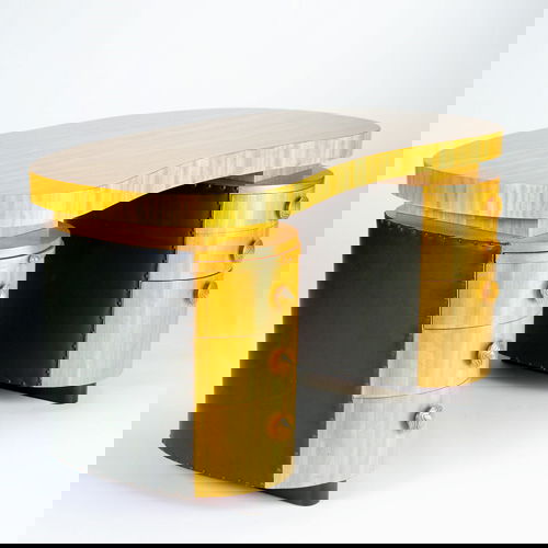 GILBERT ROHDE/HERMAN MILLER Double-pedestal Palda: GILBERT ROHDE/HERMAN MILLER Double-pedestal Paldao desk with raised kidney-shaped top covered in exotic wood veneer, over a pull-out shelf, and six drawers with circular carved pulls, the case with ta